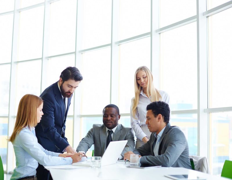 businesspeople-working-as-team-with-laptop